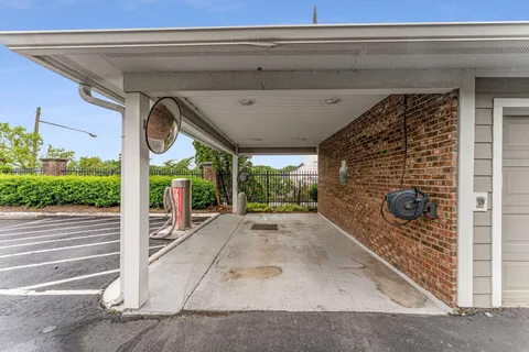 a view of a porch with a table and chairs