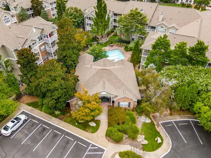 an aerial view of a house with a yard and black garage