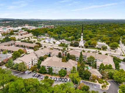 an aerial view of ocean and residential houses with outdoor space