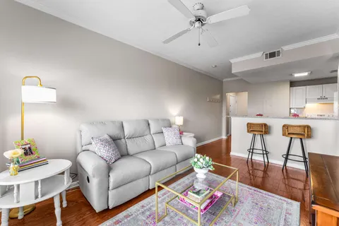 a living room with furniture and wooden floor