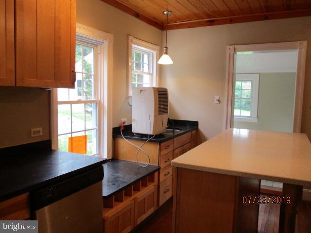 24837 Pen Mar Road Cascade, MD 21719 - Photo 12 of 32 a kitchen with stainless steel appliances a stove a refrigerator and wooden cabinets