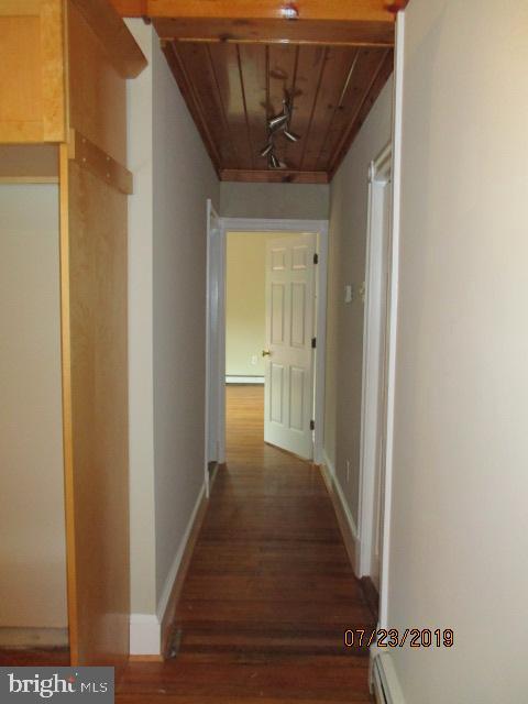 24837 Pen Mar Road Cascade, MD 21719 - Photo 15 of 32 a view of a hallway with wooden floor and a bathroom