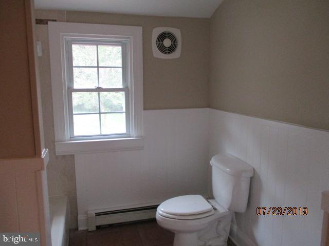 24837 Pen Mar Road Cascade, MD 21719 - Photo 17 of 32 a white toilet sitting next to a window in a bathroom