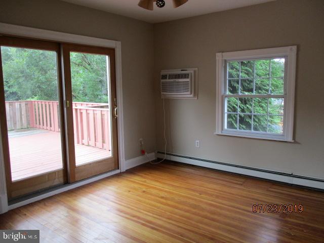 24837 Pen Mar Road Cascade, MD 21719 - Photo 19 of 32 an empty room with wooden floor and windows