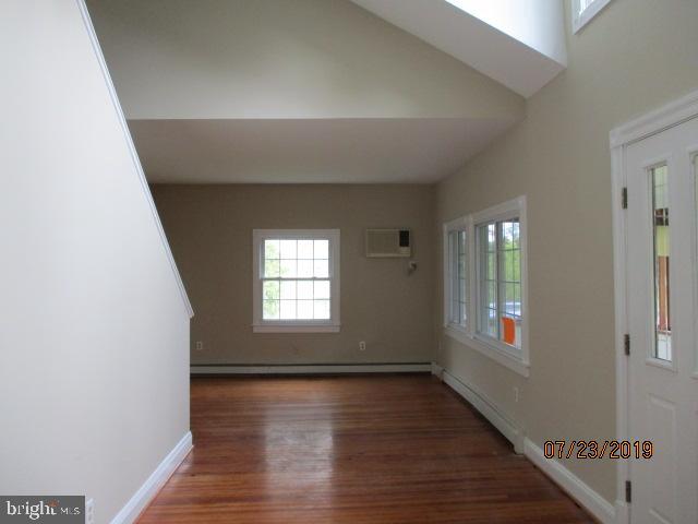 24837 Pen Mar Road Cascade, MD 21719 - Photo 20 of 32 a view of an empty room with wooden floor and a window