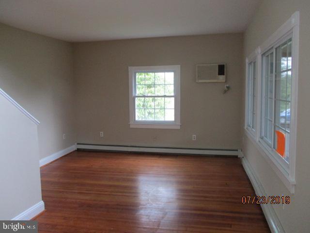 24837 Pen Mar Road Cascade, MD 21719 - Photo 21 of 32 a view of an empty room with wooden floor and a window