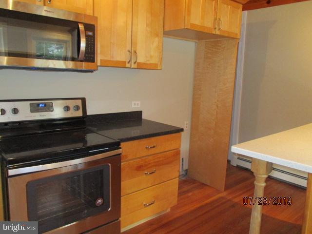 24837 Pen Mar Road Cascade, MD 21719 - Photo 6 of 32 a kitchen with granite countertop cabinets stainless steel appliances and wooden floor