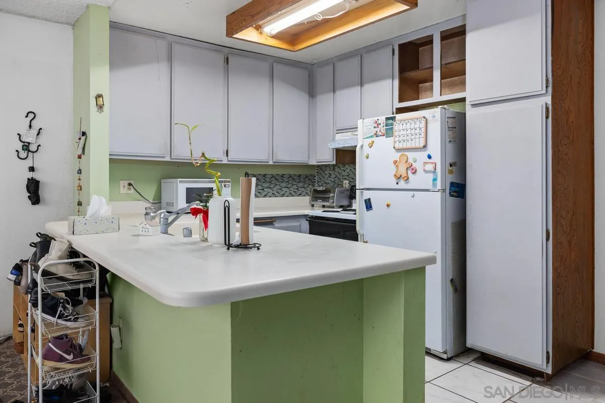 3587 Ruffin Road San Diego, CA 92123 - Photo 6 of 23 a kitchen with a sink a stove and refrigerator
