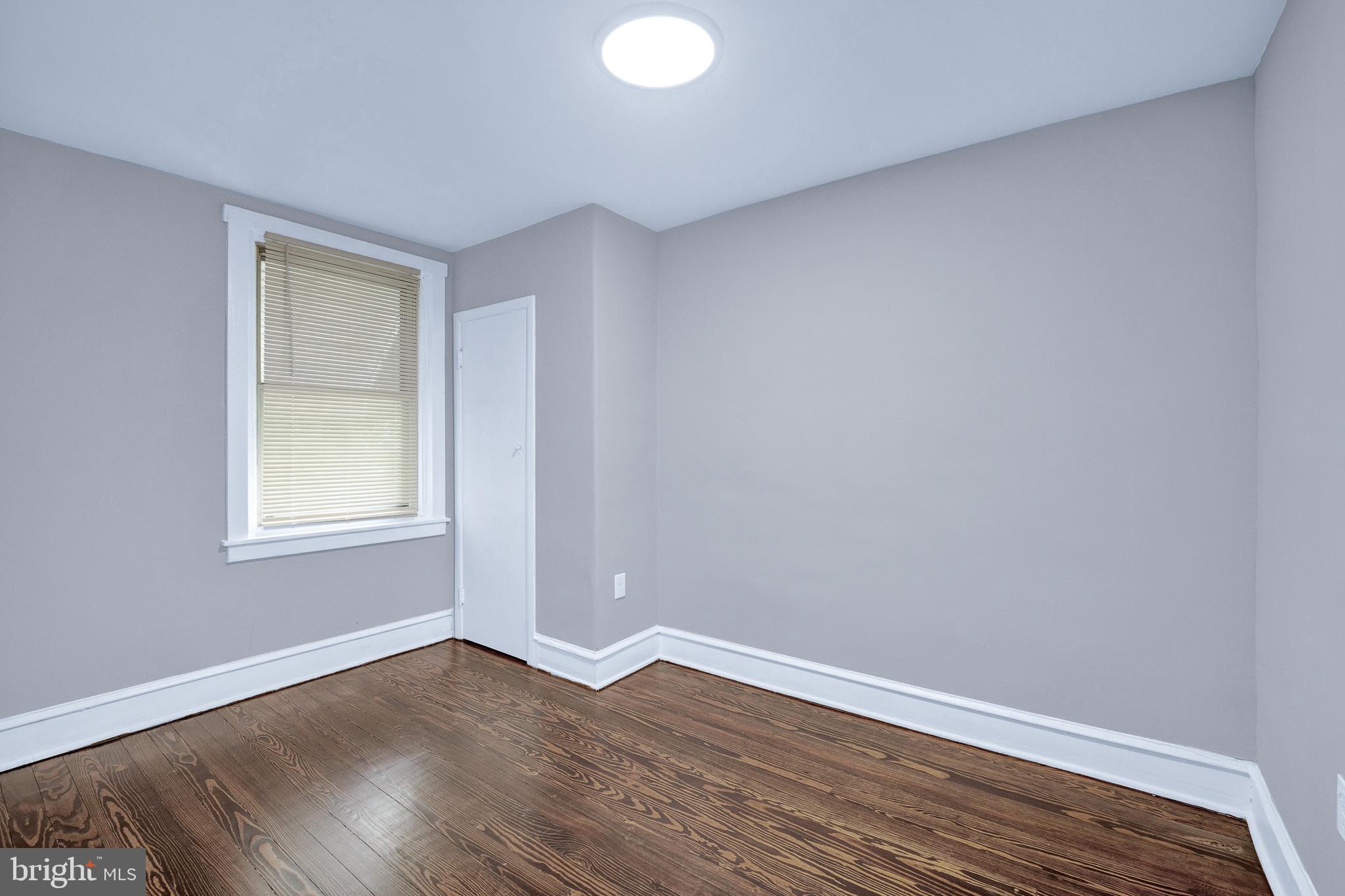 2610 Hobson Street Philadelphia, PA 19142 - Photo 11 of 13 a view of an empty room with wooden floor and a window