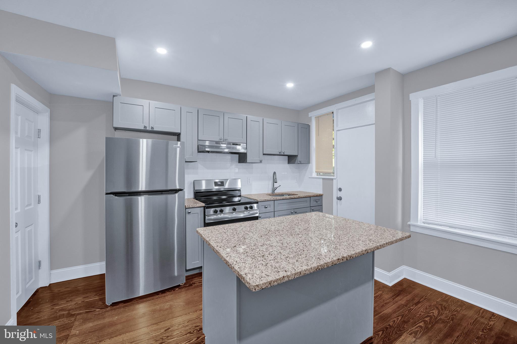 2610 Hobson Street Philadelphia, PA 19142 - Photo 5 of 13 a kitchen with a refrigerator and a stove top oven