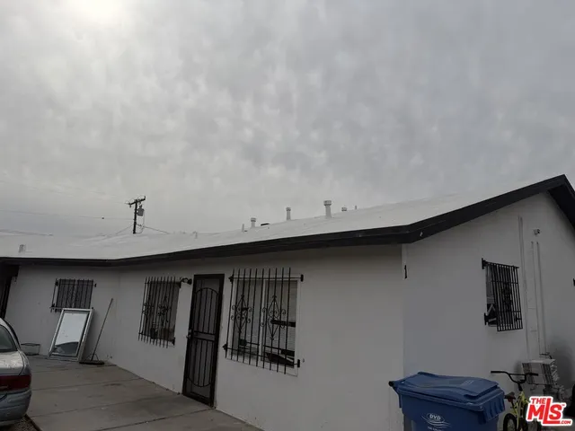 a view of a livingroom with wooden floor and a ceiling fan