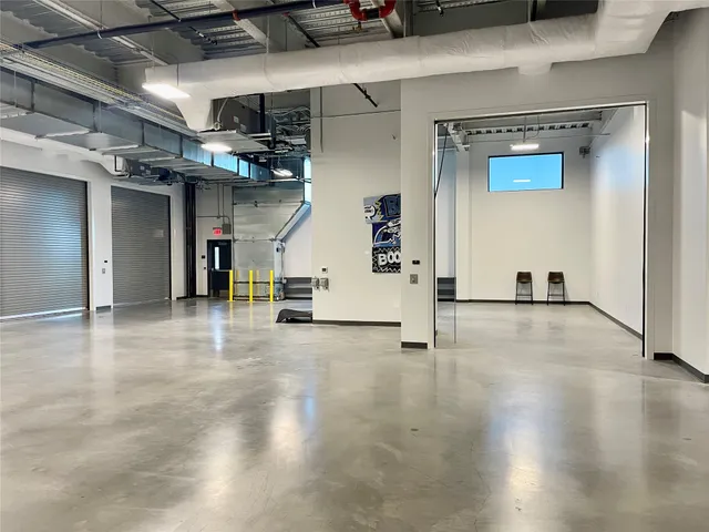 a view of room with wooden floor and furniture