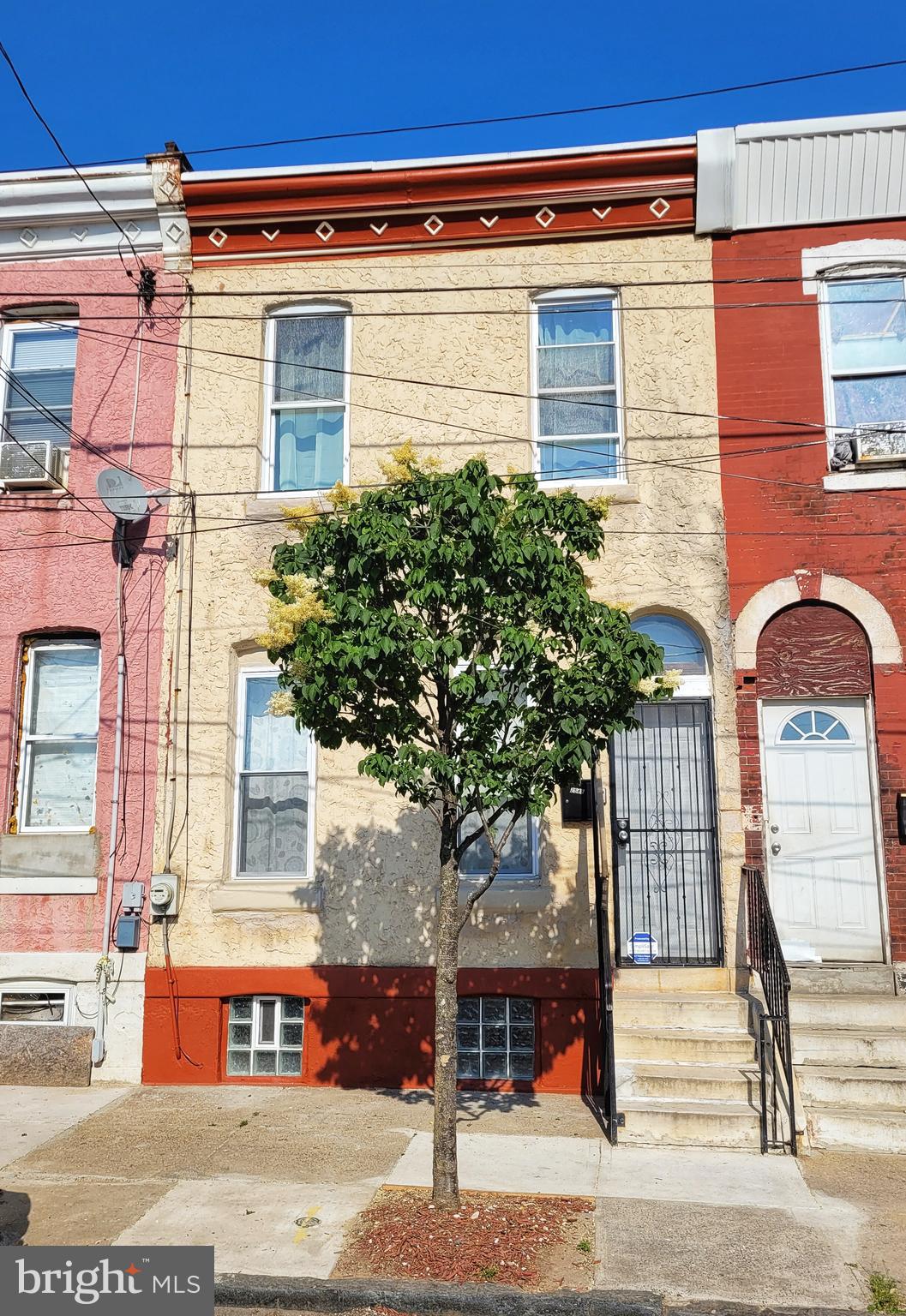 a view of a brick building with a tree