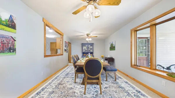 a living room with furniture and floor to ceiling windows