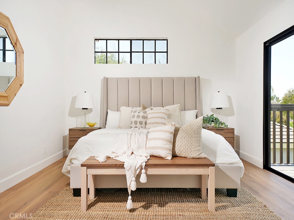 24912 Danamaple Dana Point, CA 92629 - Photo 12 of 36 a bed sitting in a bedroom next to a window with wooden floor