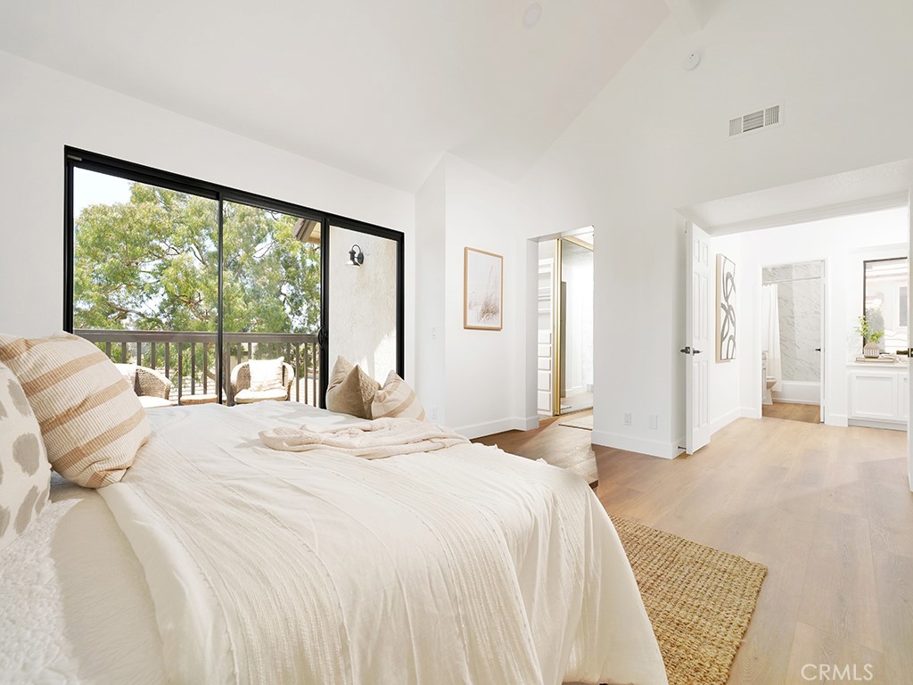 24912 Danamaple Dana Point, CA 92629 - Photo 15 of 36 a spacious bedroom with a large bed and a large window