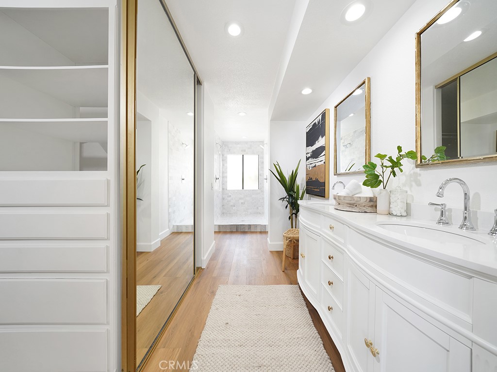 24912 Danamaple Dana Point, CA 92629 - Photo 16 of 36 a bathroom with a double vanity sink and a mirror