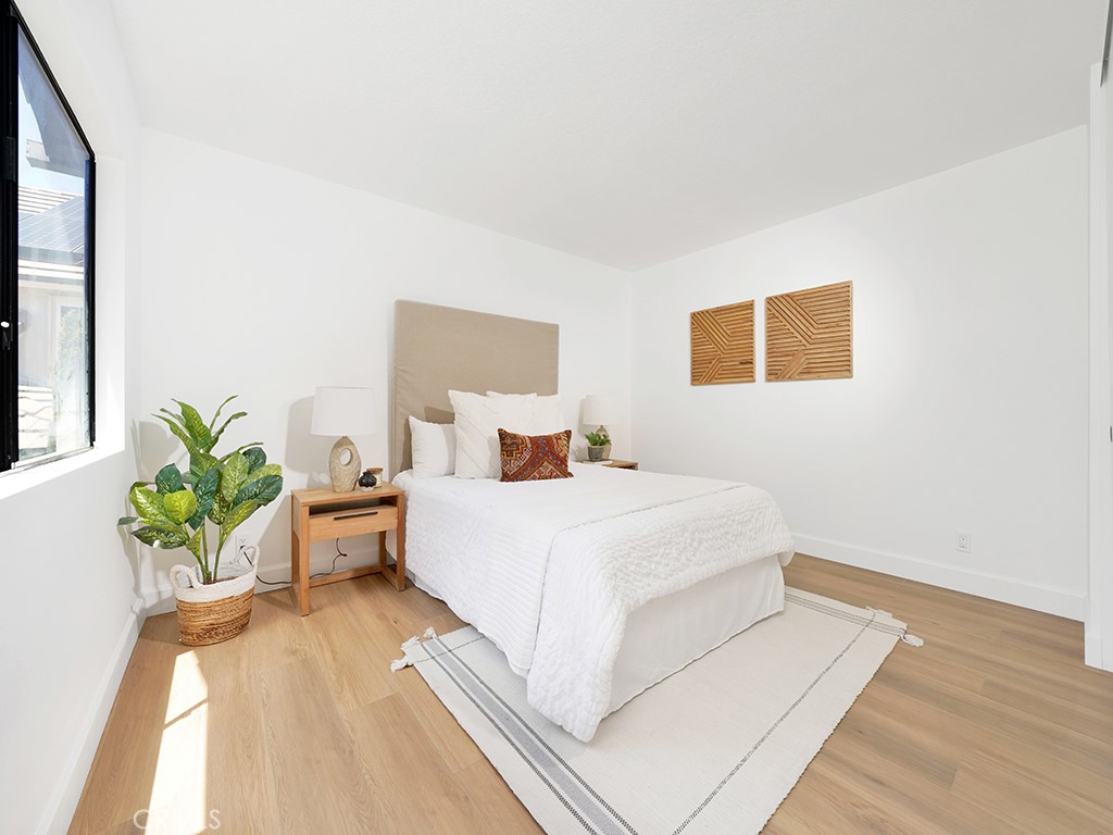 24912 Danamaple Dana Point, CA 92629 - Photo 21 of 36 a bed room with a bed and a potted plant