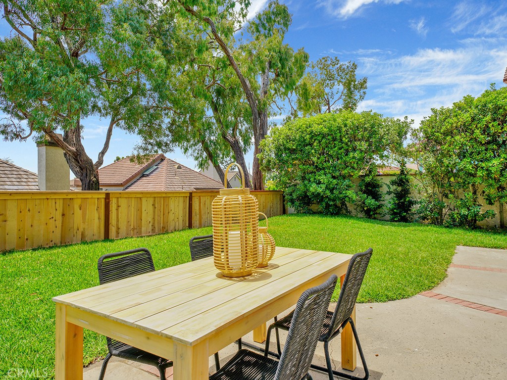 24912 Danamaple Dana Point, CA 92629 - Photo 28 of 36 a view of a patio with table and chairs potted plants and large tree