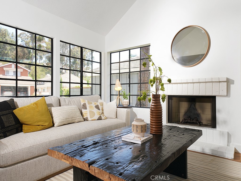 24912 Danamaple Dana Point, CA 92629 - Photo 3 of 36 a living room with furniture fireplace and a large window