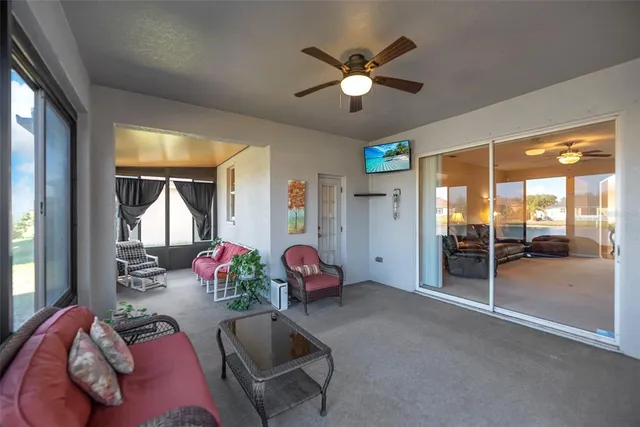 a living room with furniture and a ceiling fan