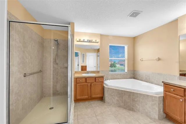 a view of a livingroom with a chandelier fan and windows