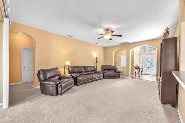 a living room with furniture and a chandelier