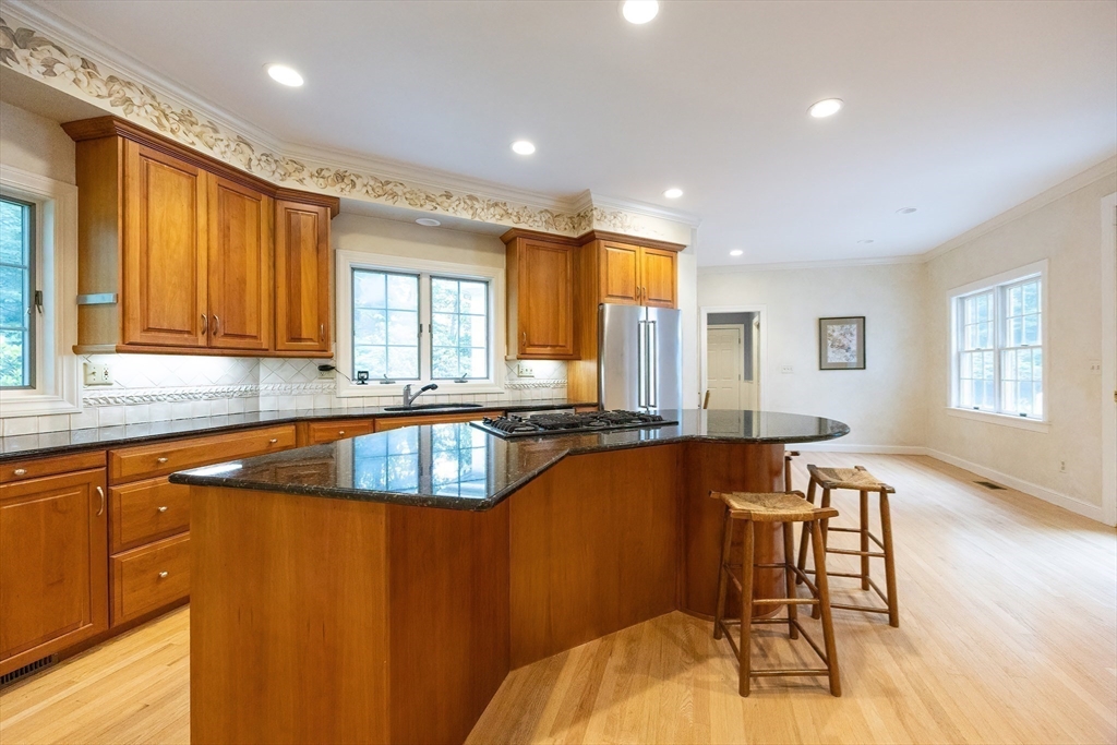 83 High Ridge Road Boxford, MA 01921 - Photo 12 of 42 a kitchen with a table chairs in it and wooden floors