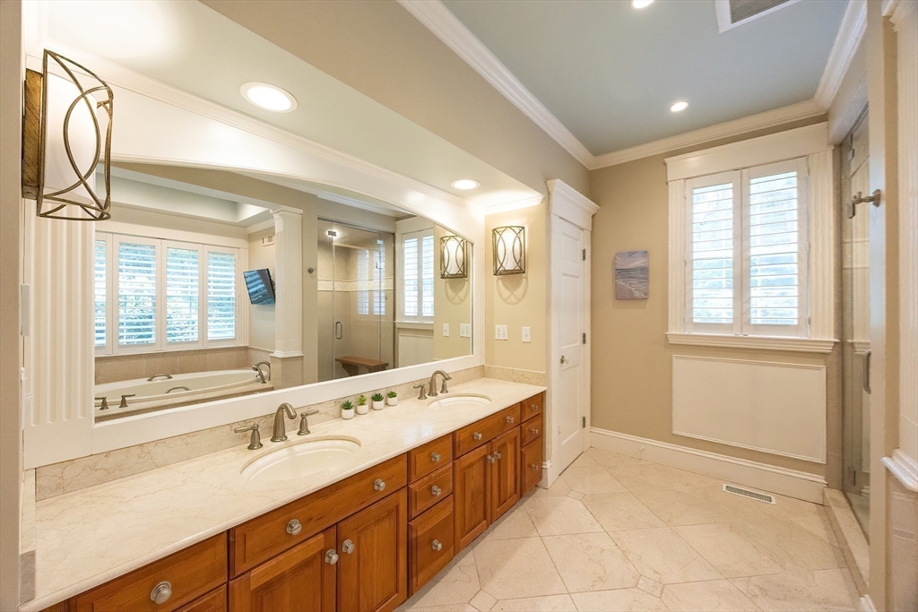 83 High Ridge Road Boxford, MA 01921 - Photo 17 of 42 a spacious bathroom with a double vanity sink a large mirror and a bathtub