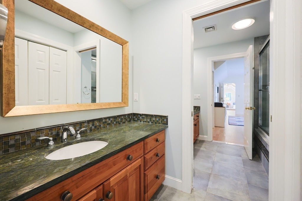 83 High Ridge Road Boxford, MA 01921 - Photo 24 of 42 a bathroom with a granite countertop sink and a mirror