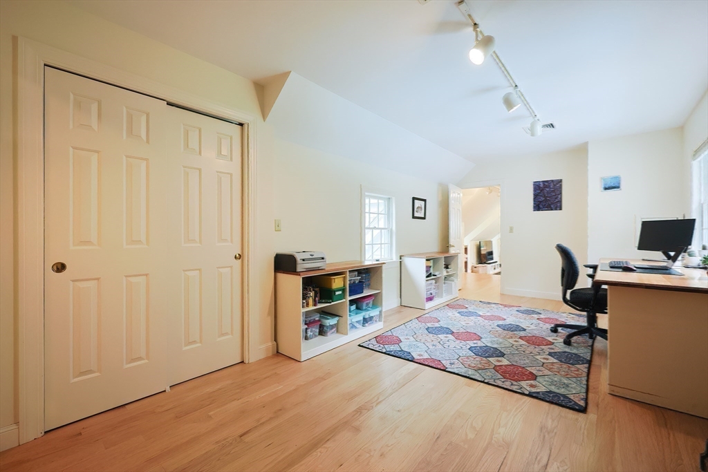 83 High Ridge Road Boxford, MA 01921 - Photo 25 of 42 a bedroom with a bed and a flat tv screen on the dresser