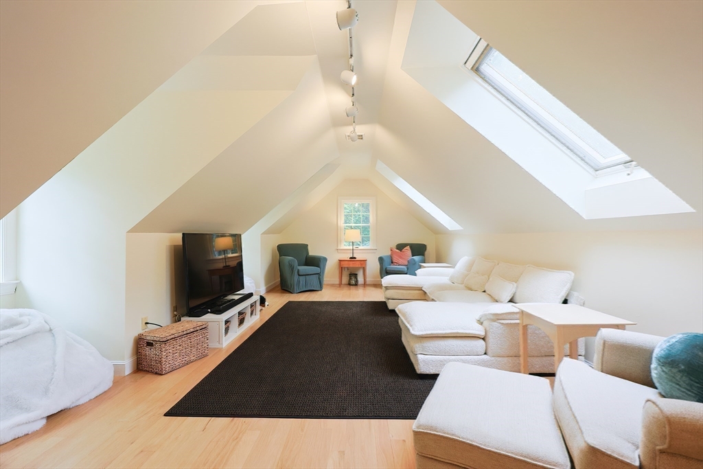 83 High Ridge Road Boxford, MA 01921 - Photo 26 of 42 a living room with furniture a flat screen tv and a large window