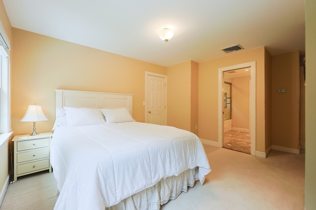 83 High Ridge Road Boxford, MA 01921 - Photo 30 of 42 a bedroom with a bed and a walk in closet