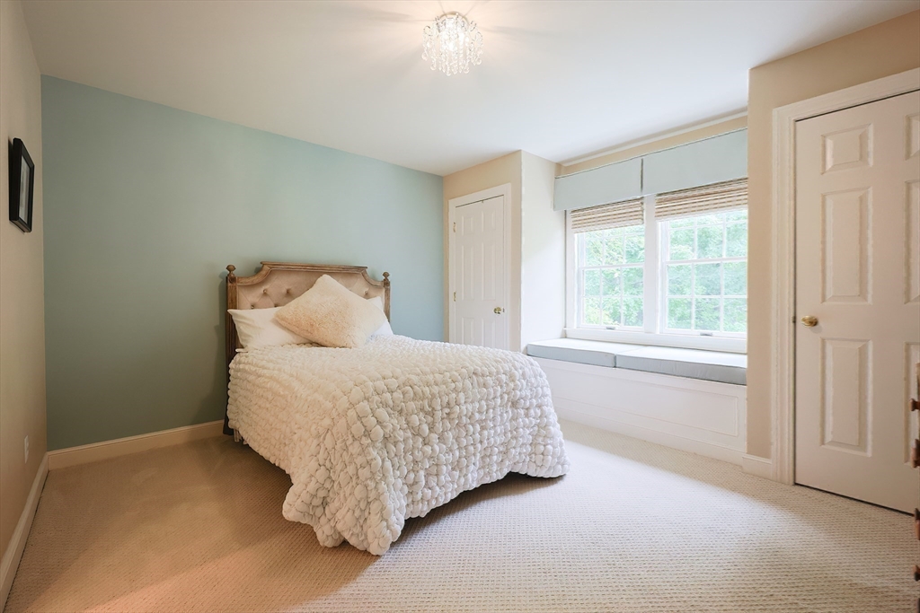 83 High Ridge Road Boxford, MA 01921 - Photo 32 of 42 a bed sitting in a bedroom next to a window
