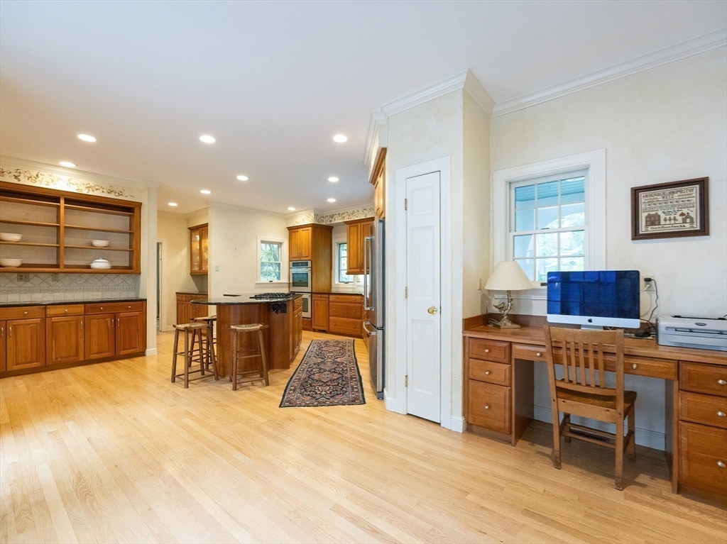 83 High Ridge Road Boxford, MA 01921 - Photo 10 of 42 a view of a kitchen with kitchen island granite countertop a sink cabinets and stainless steel appliances