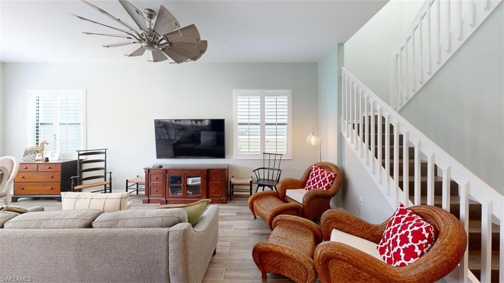 8943 Madrid Circle Naples, FL 34104 - Photo 12 of 13 a living room with furniture or couch and a flat screen tv