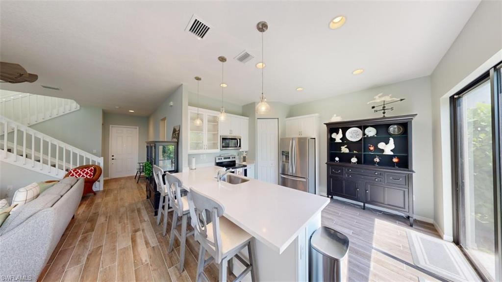 8943 Madrid Circle Naples, FL 34104 - Photo 4 of 13 a view of a dining room with furniture window and wooden floor
