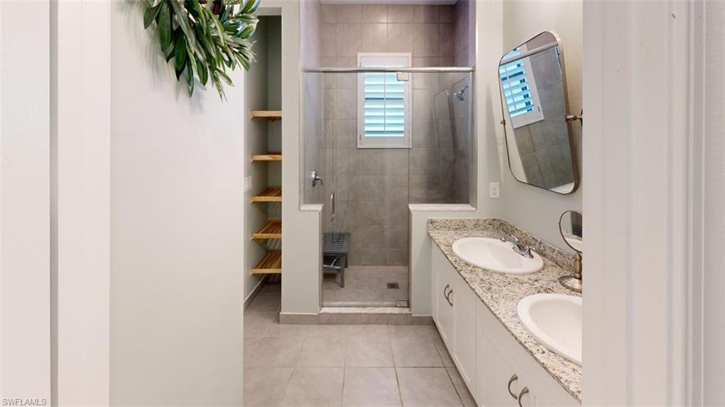 8943 Madrid Circle Naples, FL 34104 - Photo 9 of 13 a spacious bathroom with a bathtub and a sink