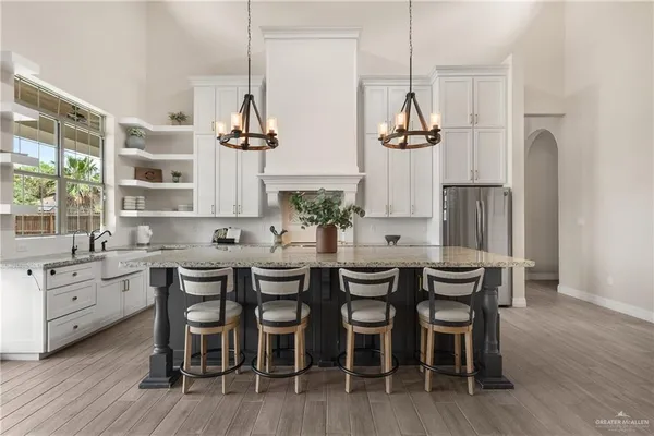a dining room with furniture a chandelier and wooden floor
