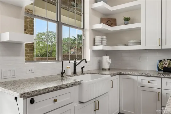 a kitchen with granite countertop a sink and a window