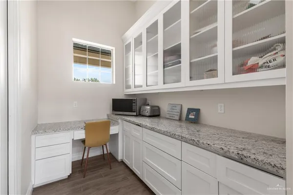 a view of cabinets and wooden floor
