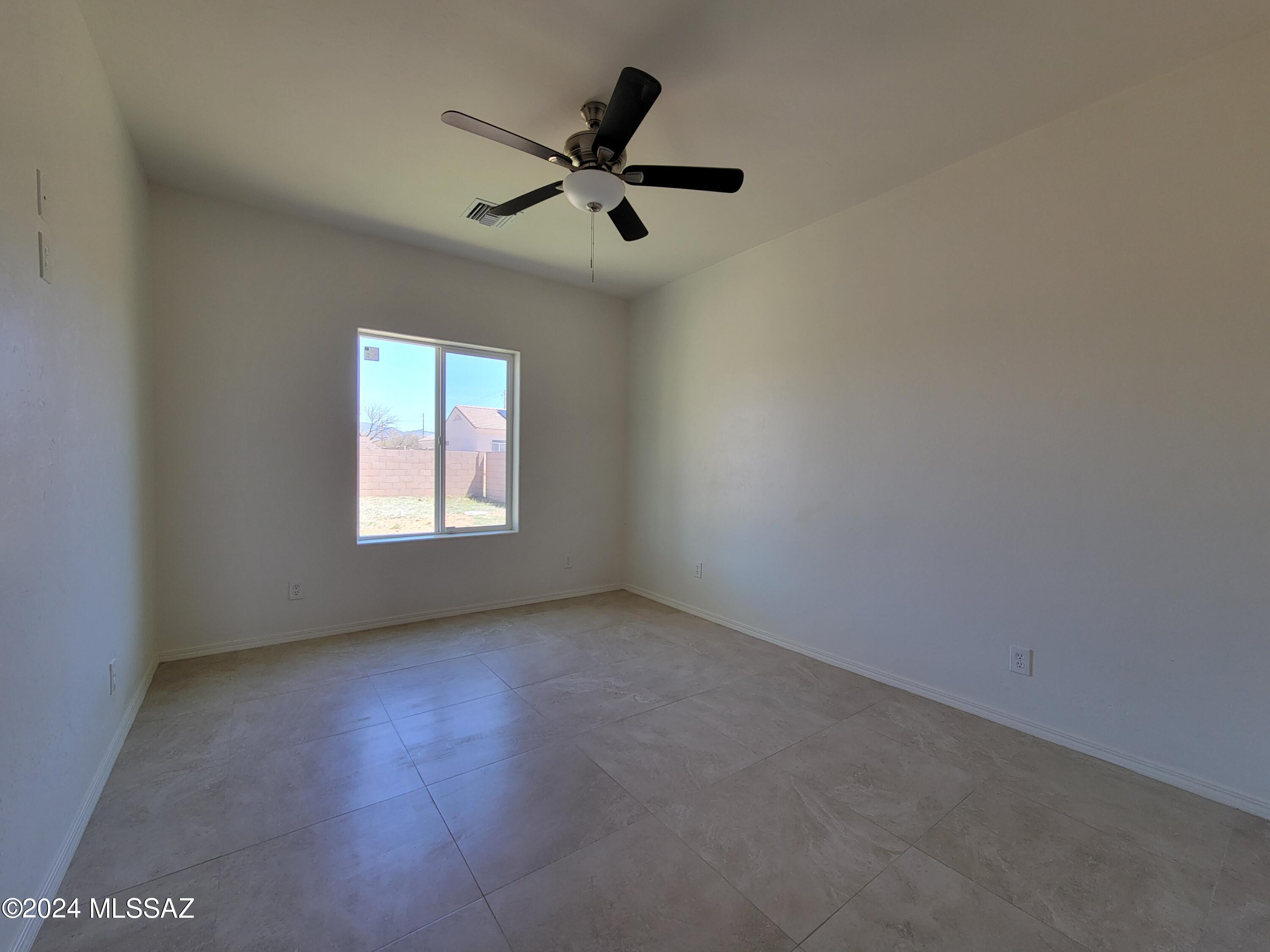 1763 Aguila Court Rio Rico, AZ 85648 - Photo 23 of 34 an empty room with a window