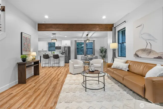 a view of a living room kitchen and a wooden floor