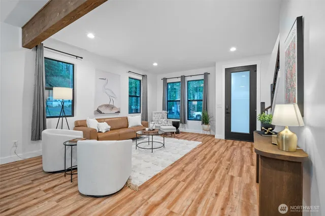 a living room with furniture windows and wooden floor