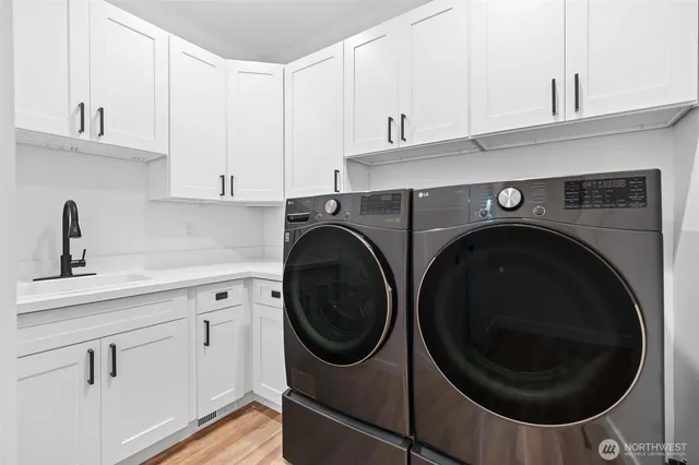 a utility room with sink dryer and washer