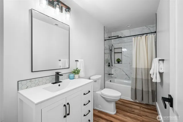 a bathroom with a sink toilet a shower and a mirror