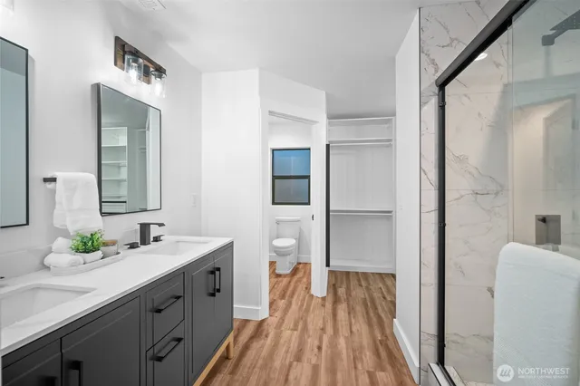 a spacious bathroom with a double vanity sink and a mirror