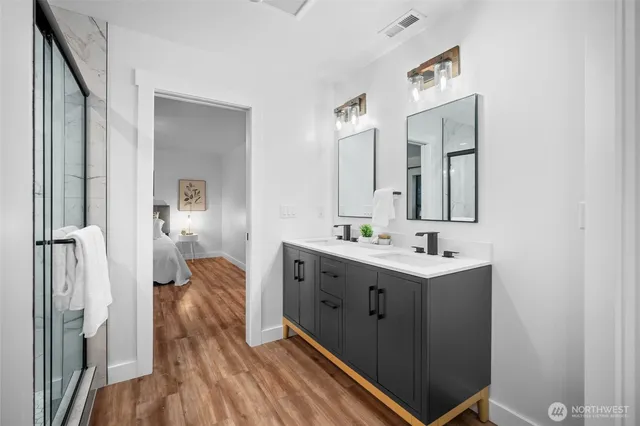 a spacious bathroom with a double vanity sink and mirror