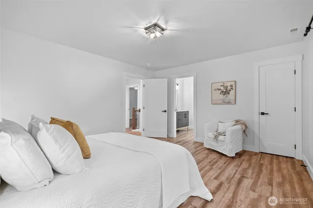 a bedroom with a bed and a couch