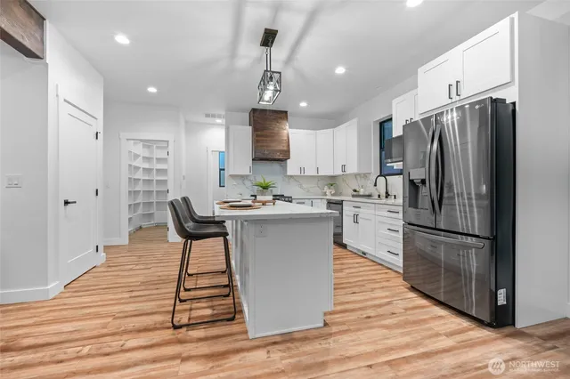 a kitchen with stainless steel appliances a refrigerator stove microwave and cabinets